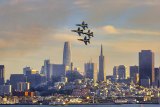 The Blue Angels dramatically fly over downtown San Francisco during Fleet Week.